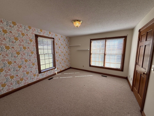 unfurnished bedroom featuring carpet and a textured ceiling