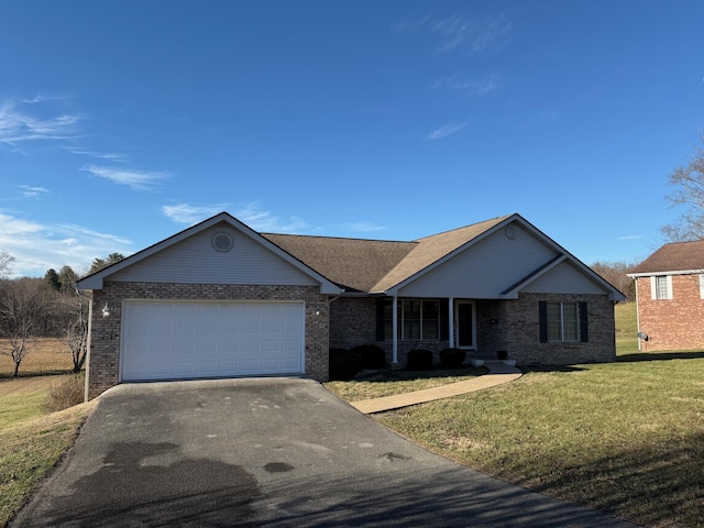 single story home featuring a garage and a front yard