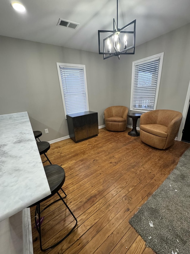 living room with wood-type flooring and a chandelier