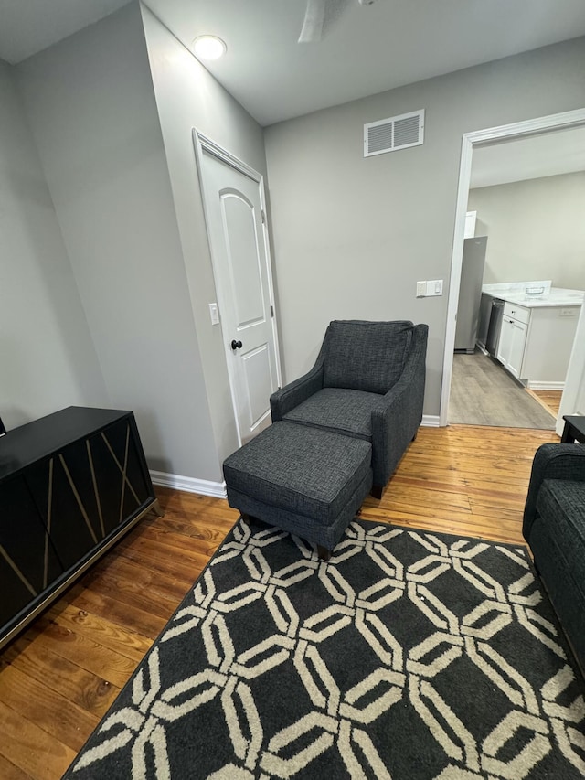 sitting room with wood-type flooring