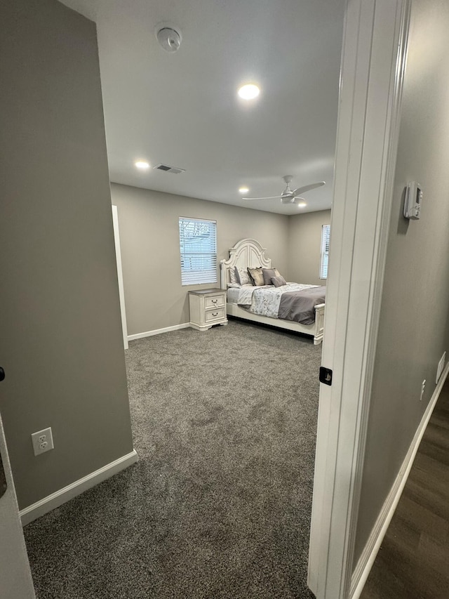 bedroom featuring dark colored carpet and ceiling fan