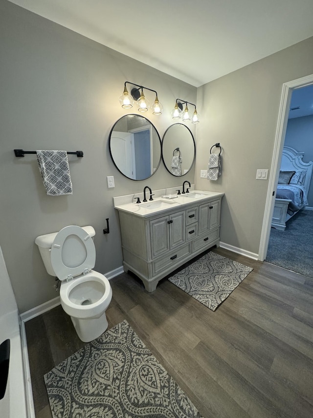 bathroom featuring vanity, toilet, and hardwood / wood-style floors