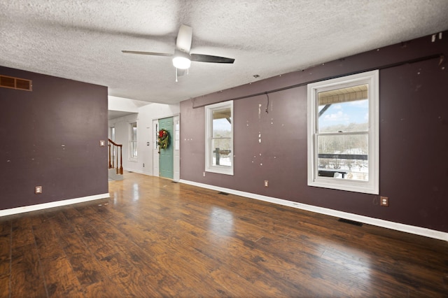 unfurnished living room with a textured ceiling, ceiling fan, and wood-type flooring