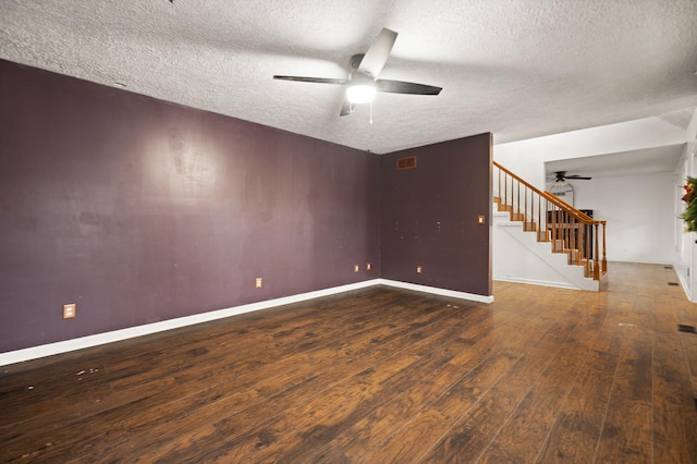 unfurnished room featuring a textured ceiling, ceiling fan, and dark hardwood / wood-style floors