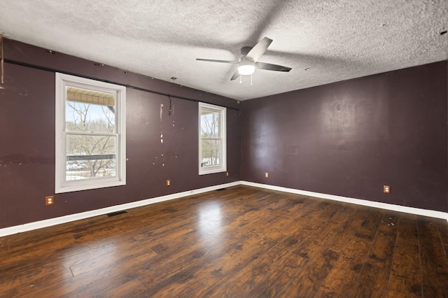 unfurnished room featuring ceiling fan, a textured ceiling, and dark hardwood / wood-style floors