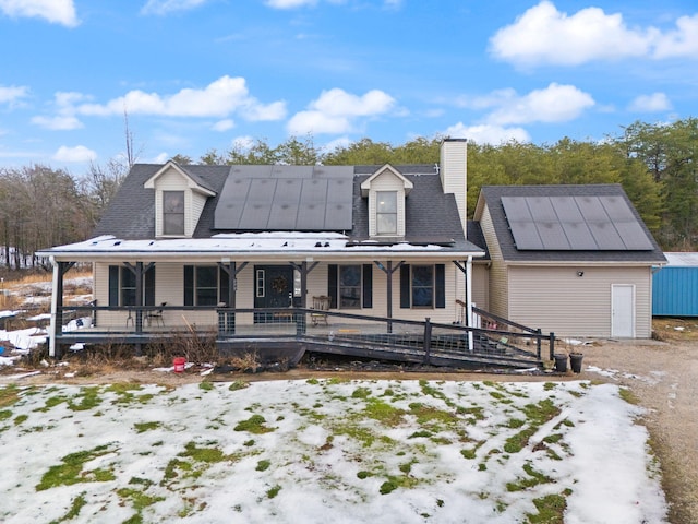 view of front of home featuring solar panels and a porch