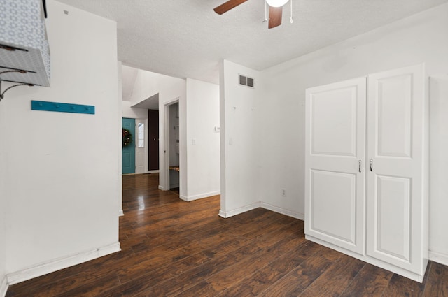 unfurnished room with ceiling fan and dark hardwood / wood-style flooring