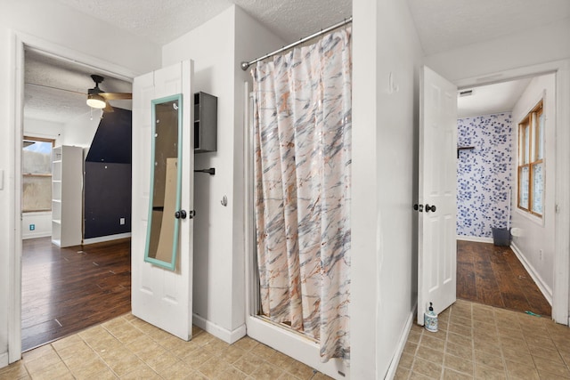 bathroom featuring ceiling fan and a textured ceiling