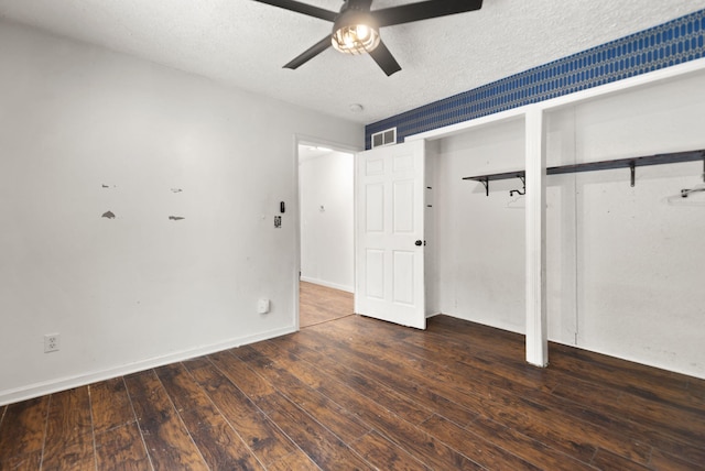 unfurnished bedroom featuring a textured ceiling, ceiling fan, and dark hardwood / wood-style flooring