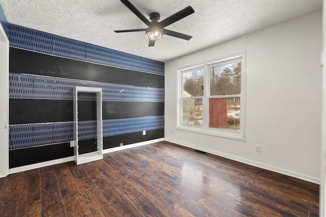 empty room featuring hardwood / wood-style flooring, a textured ceiling, and ceiling fan