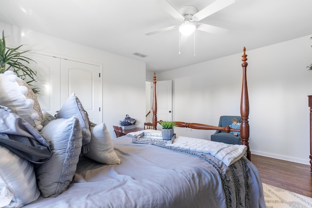 bedroom featuring ceiling fan, a closet, and hardwood / wood-style flooring