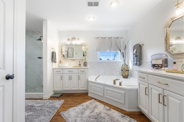 bathroom with vanity, shower with separate bathtub, and hardwood / wood-style floors