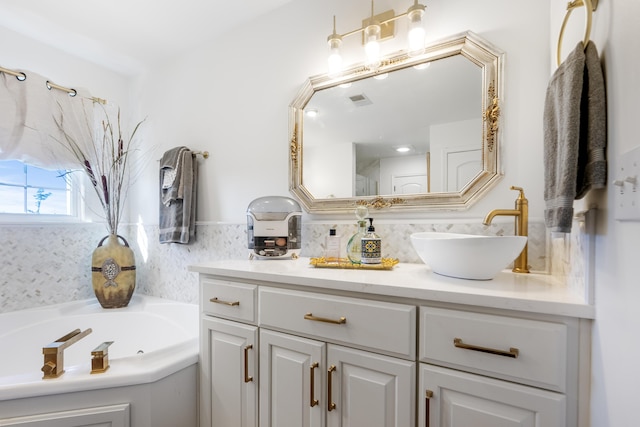 bathroom with a tub, tasteful backsplash, and vanity