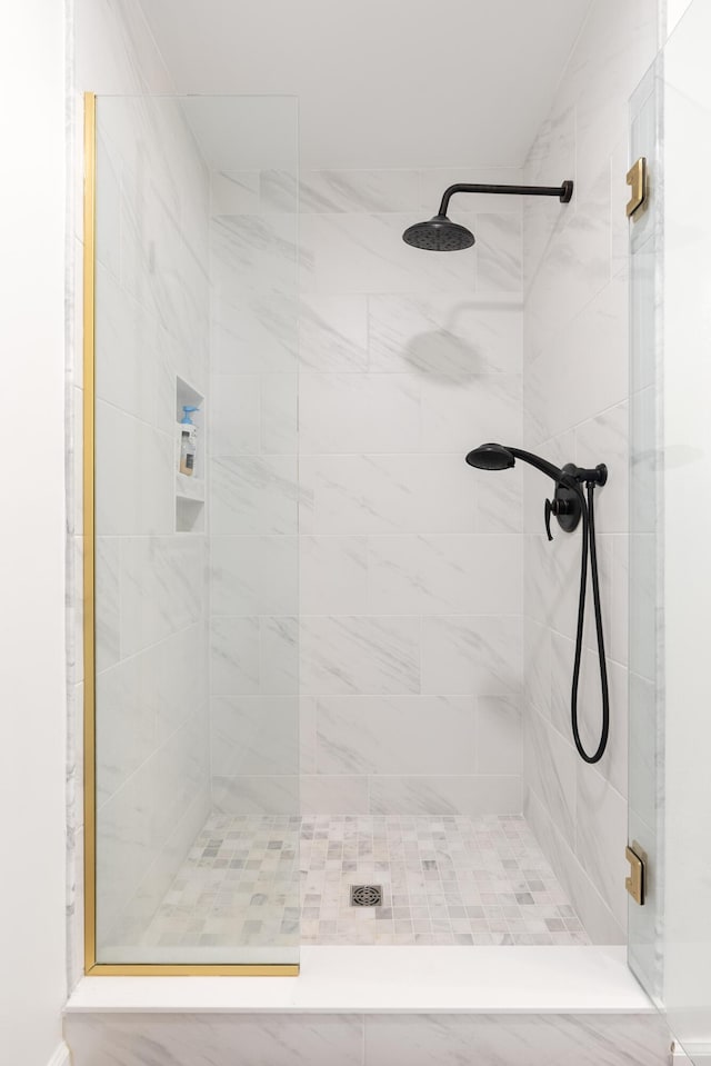 bathroom with a shower with shower door