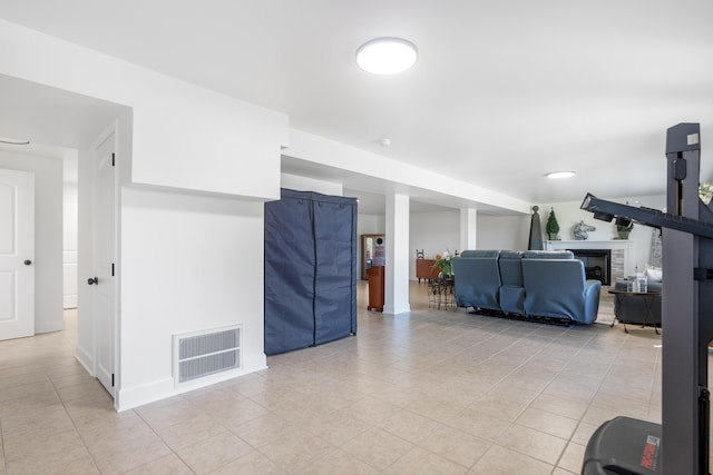 living room with light tile patterned floors and a fireplace