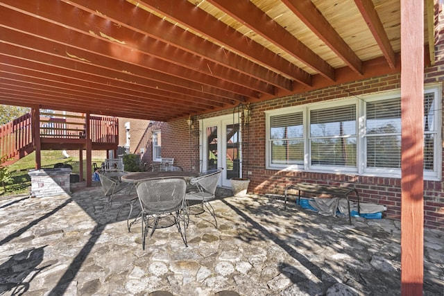 view of patio featuring a wooden deck and french doors