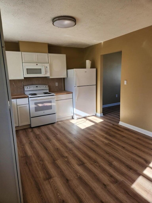 kitchen featuring a textured ceiling, white appliances, white cabinetry, and dark hardwood / wood-style floors