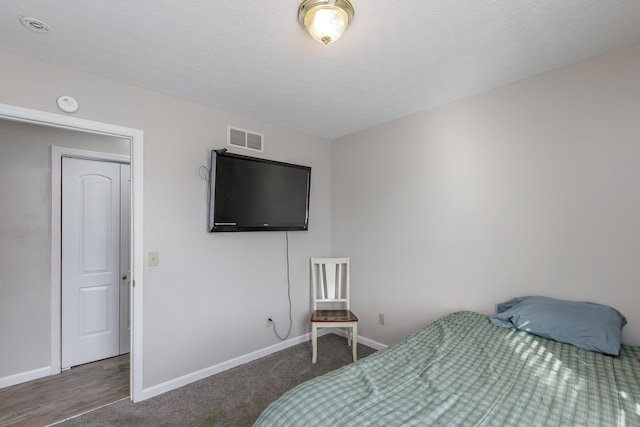 bedroom featuring dark colored carpet