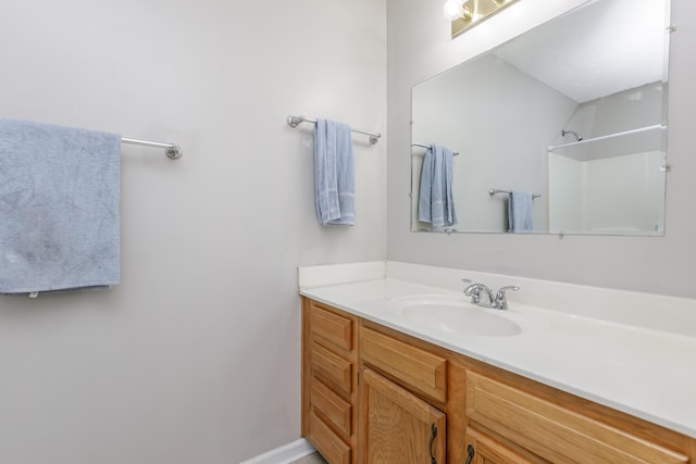 bathroom with vanity and a shower