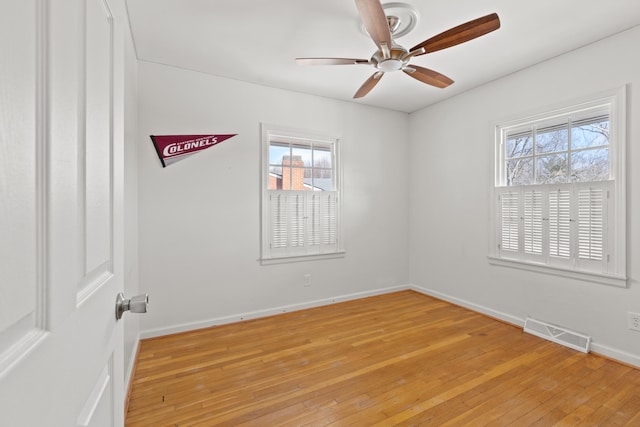 spare room featuring hardwood / wood-style flooring and ceiling fan