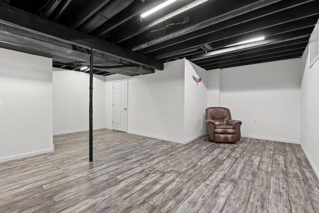 basement featuring wood-type flooring