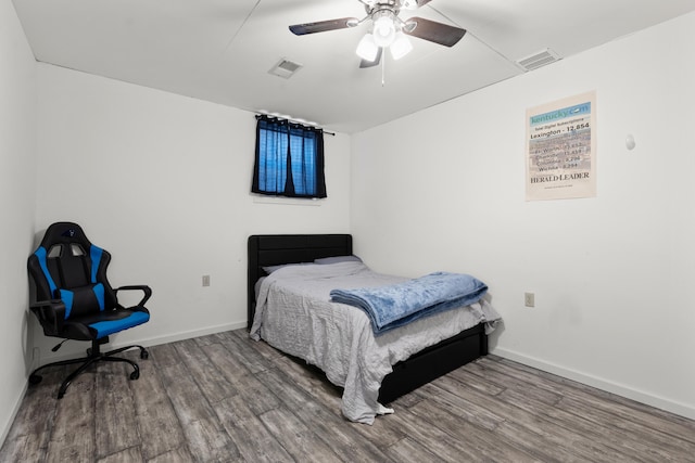 bedroom featuring hardwood / wood-style flooring and ceiling fan