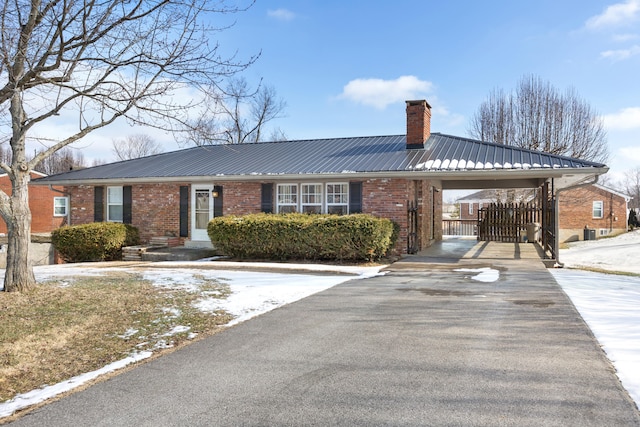 view of front facade featuring cooling unit and a carport