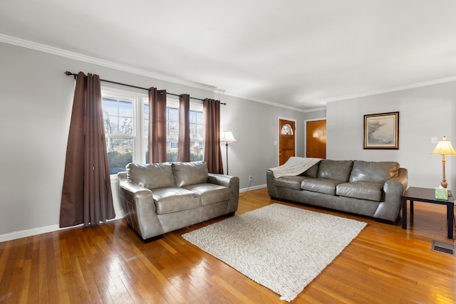 living room featuring hardwood / wood-style flooring and ornamental molding