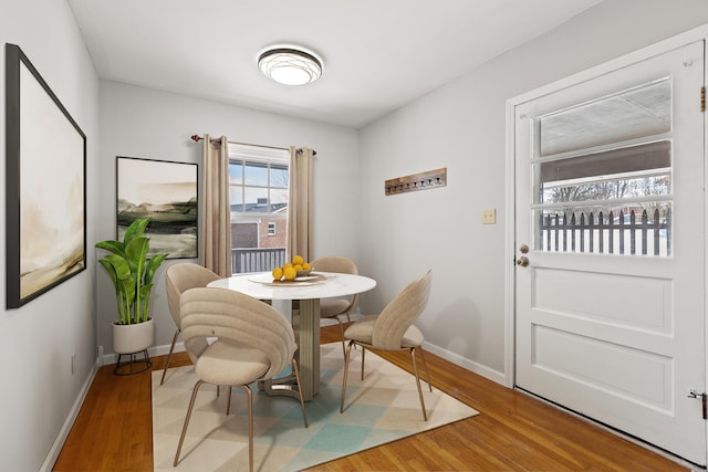 dining space with wood-type flooring