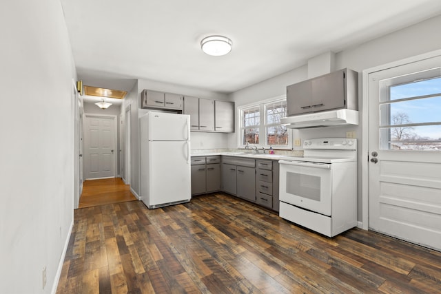 kitchen with gray cabinetry, sink, white appliances, and dark hardwood / wood-style floors