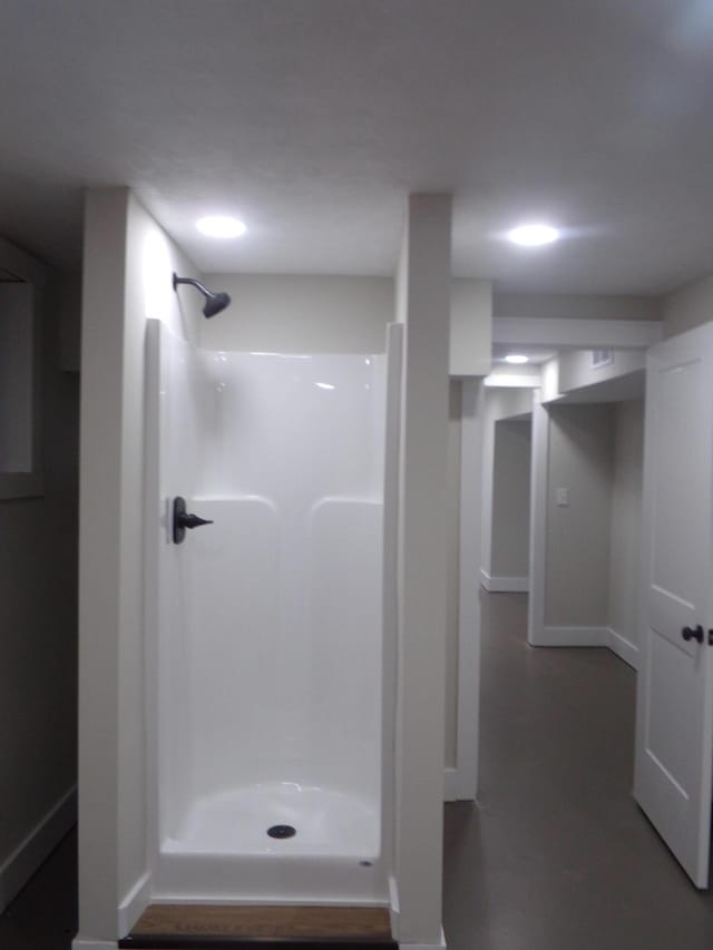 full bath featuring baseboards and walk in shower