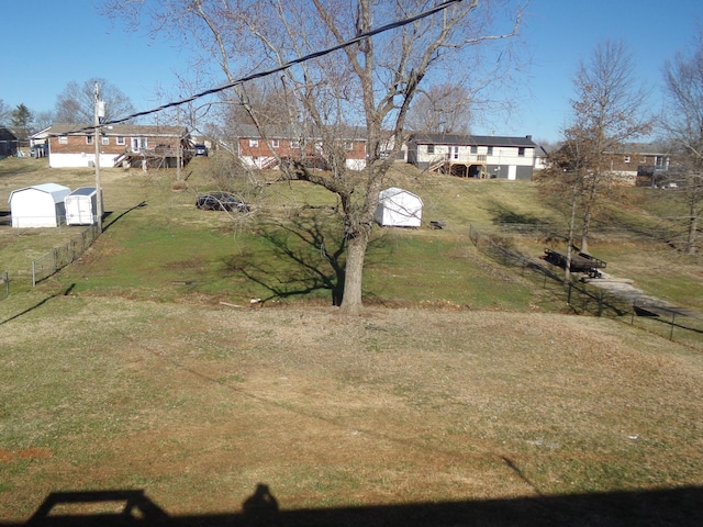 view of yard featuring an outbuilding and fence