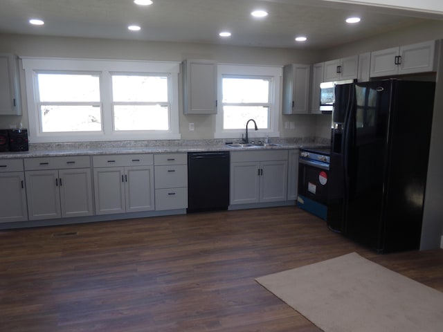 kitchen with recessed lighting, dark wood-style flooring, a sink, and black appliances