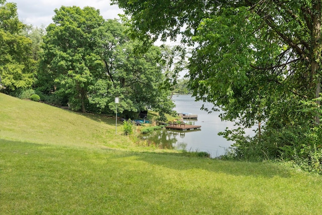 view of yard featuring a boat dock and a water view