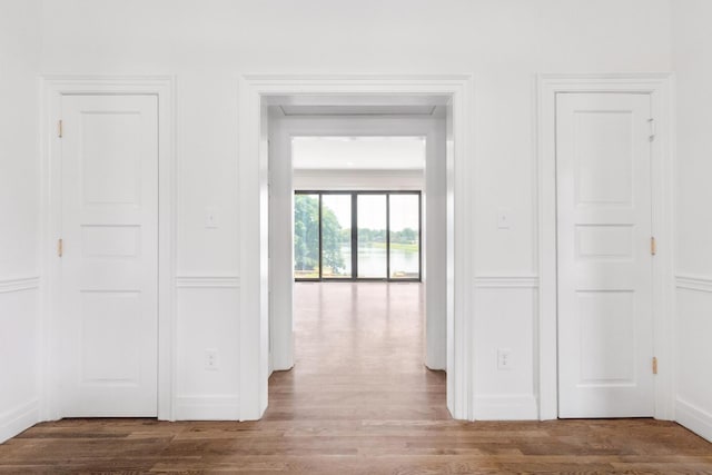 hallway with hardwood / wood-style flooring