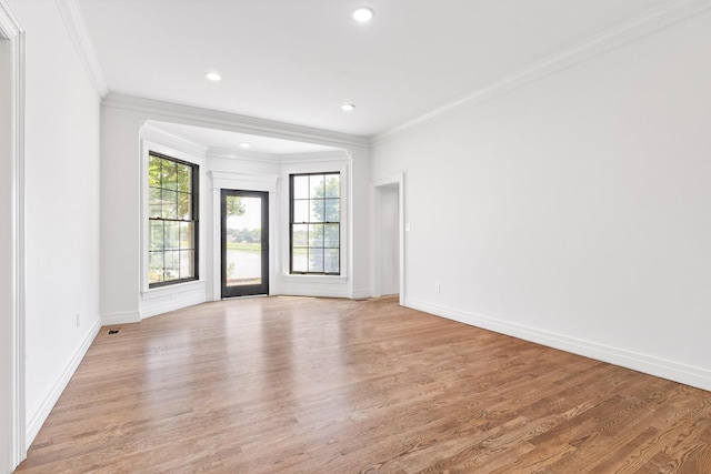 unfurnished room featuring light hardwood / wood-style flooring and crown molding