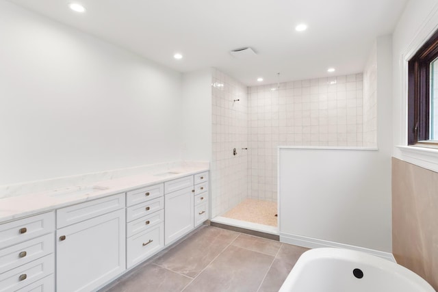 bathroom with tile patterned flooring, vanity, and shower with separate bathtub