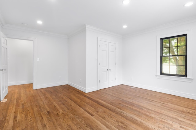 unfurnished room featuring light wood-type flooring and ornamental molding