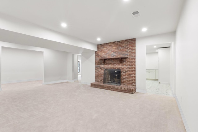 unfurnished living room with light carpet and a fireplace