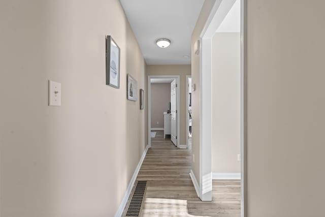 corridor featuring light hardwood / wood-style floors