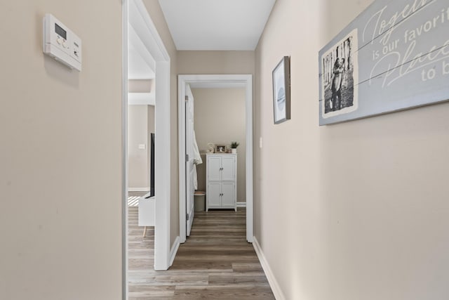 corridor with hardwood / wood-style floors