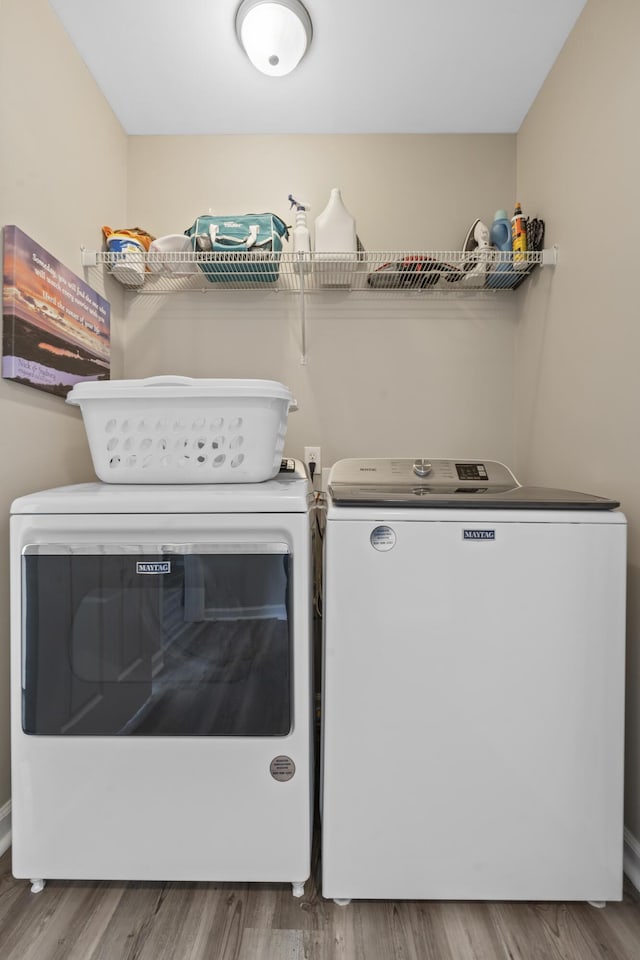 laundry area featuring hardwood / wood-style floors and washing machine and dryer