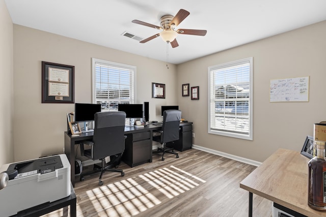 office space with light hardwood / wood-style flooring and ceiling fan