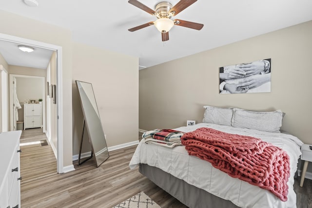 bedroom with light hardwood / wood-style floors and ceiling fan