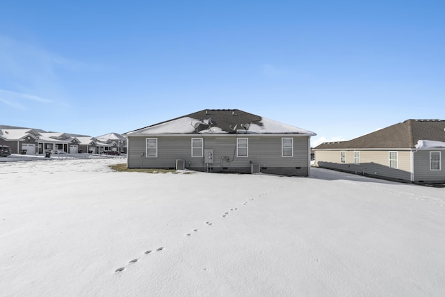 view of snow covered rear of property