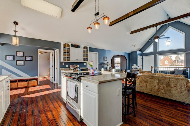 kitchen with pendant lighting, white cabinets, stainless steel range oven, and lofted ceiling with beams