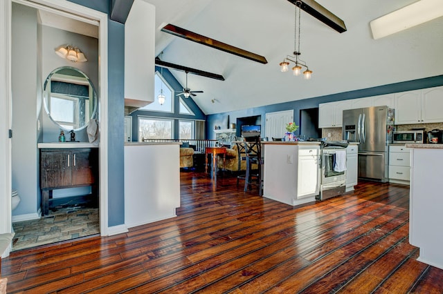 kitchen with tasteful backsplash, white cabinetry, beam ceiling, pendant lighting, and stainless steel appliances