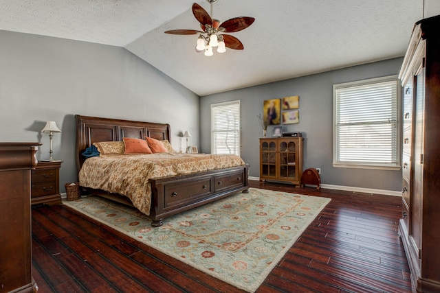 bedroom featuring ceiling fan, a textured ceiling, dark hardwood / wood-style floors, and vaulted ceiling