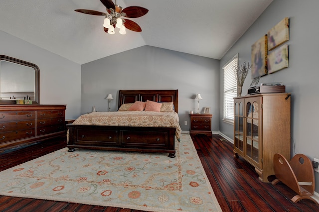 bedroom with ceiling fan, dark hardwood / wood-style floors, and lofted ceiling