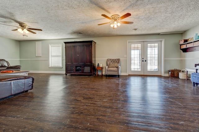 living area featuring ceiling fan, french doors, a textured ceiling, and dark hardwood / wood-style flooring